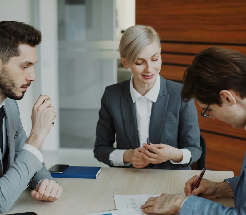 Business professionals signing a property contract